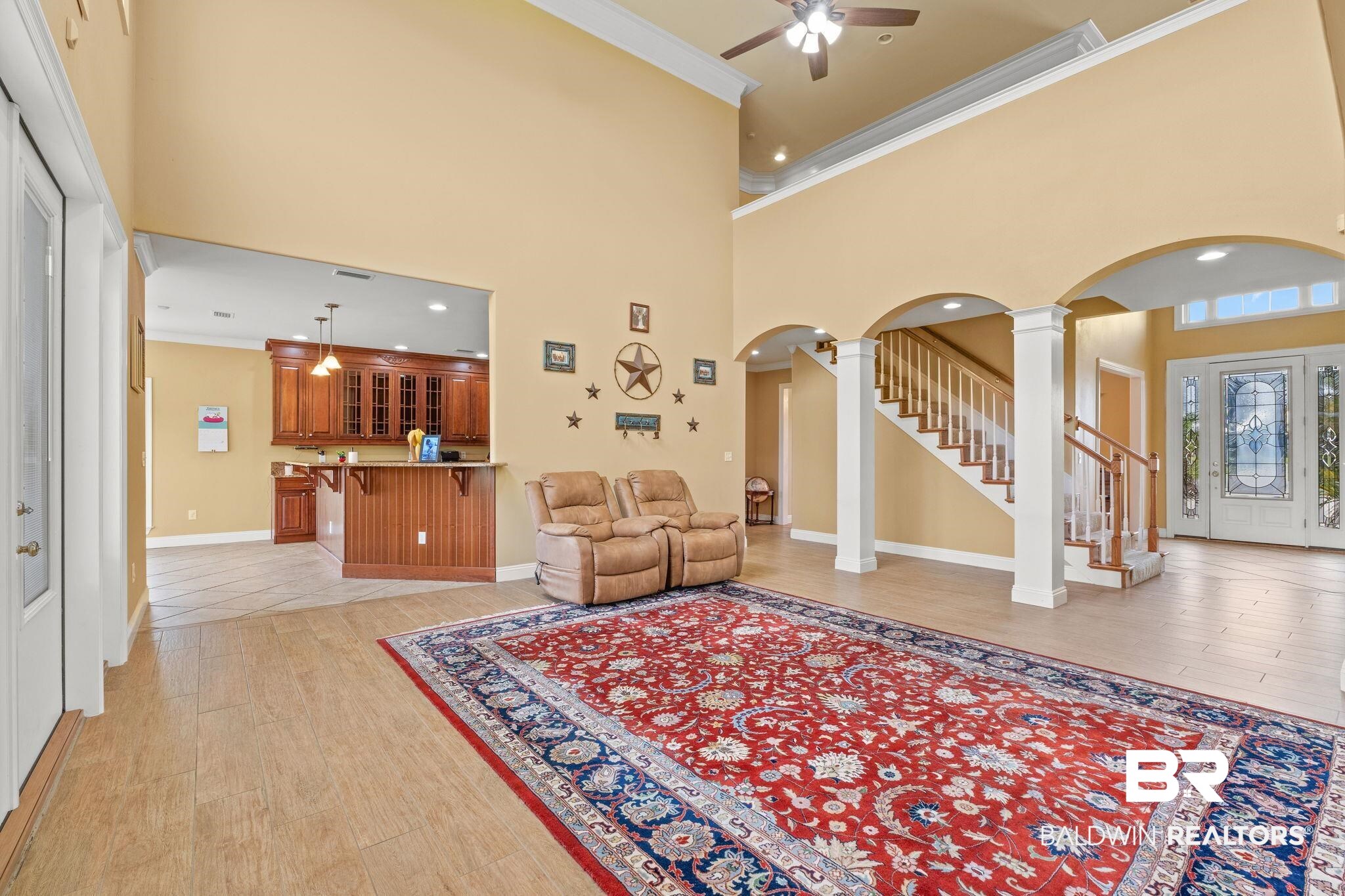 9790 Stucki Road Elberta, AL 36530 - Photo 30 of 72 Foyer entrance with arched walkways, ornamental molding, ornate columns, a ceiling fan, and stairway
