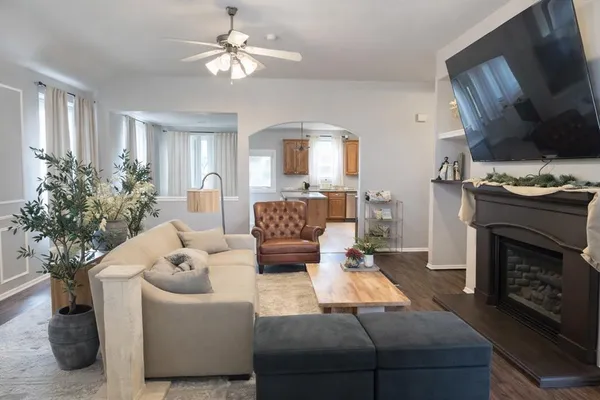 a living room with furniture fireplace and potted plant