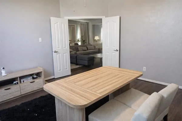 a room with a bed and a dresser