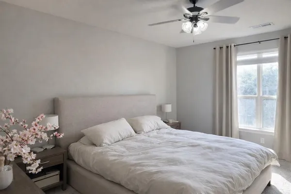a bedroom with a bed and a chandelier