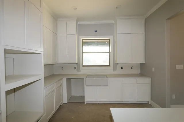 a kitchen with a sink cabinets and window