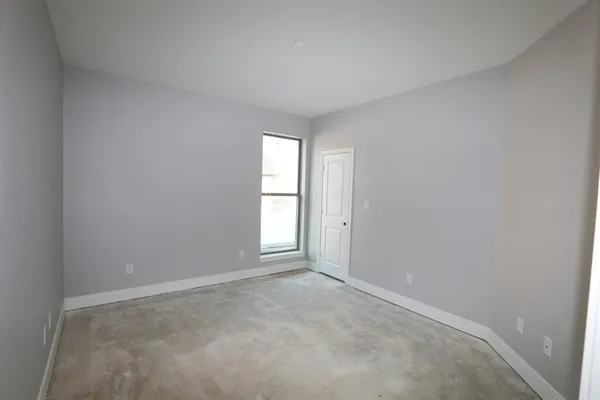 an empty room with windows and closet