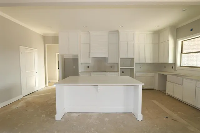 a view of kitchen with stainless steel appliances cabinets