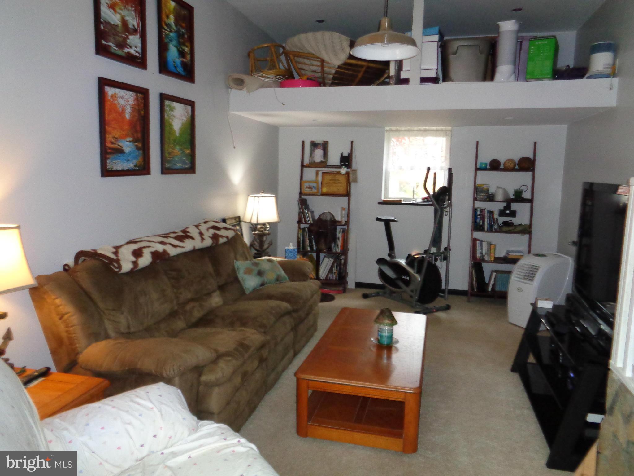 5308 Forge Road White Marsh, MD 21162 - Photo 12 of 26 a living room with furniture a window and gym equipment