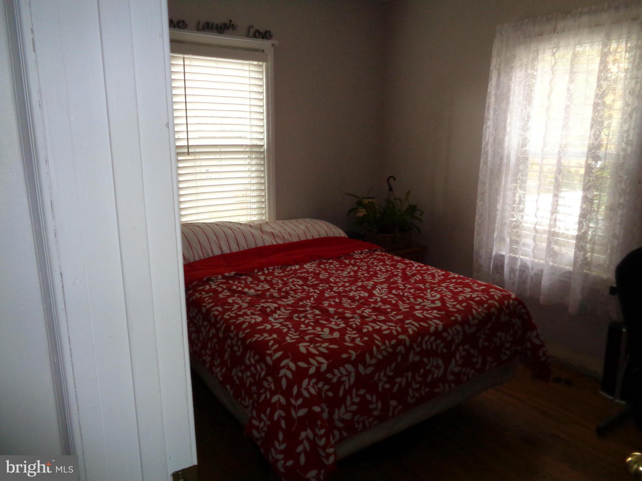 5308 Forge Road White Marsh, MD 21162 - Photo 16 of 26 a bed sitting in a bedroom next to a window