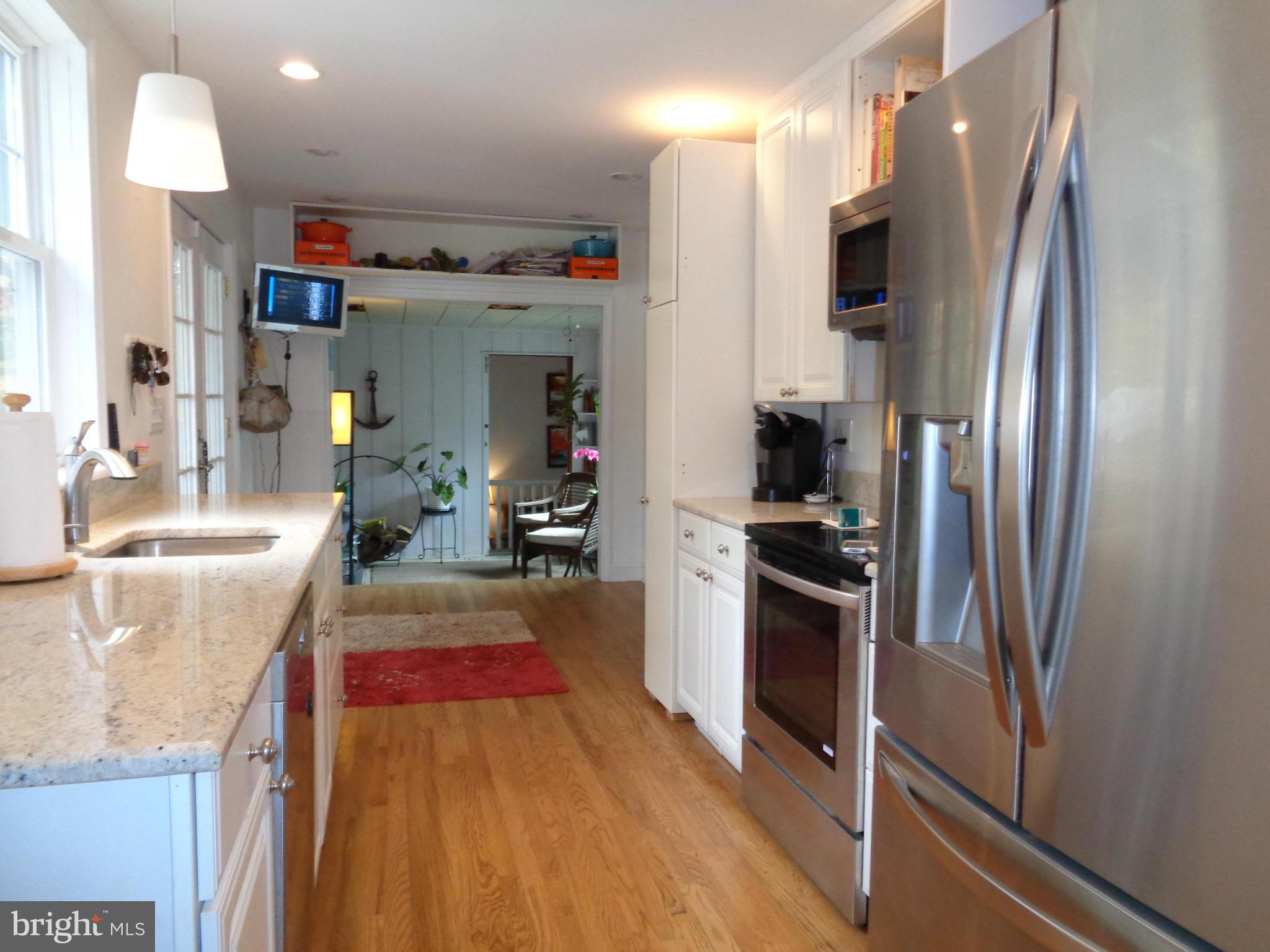 5308 Forge Road White Marsh, MD 21162 - Photo 8 of 26 a kitchen with refrigerator and cabinets