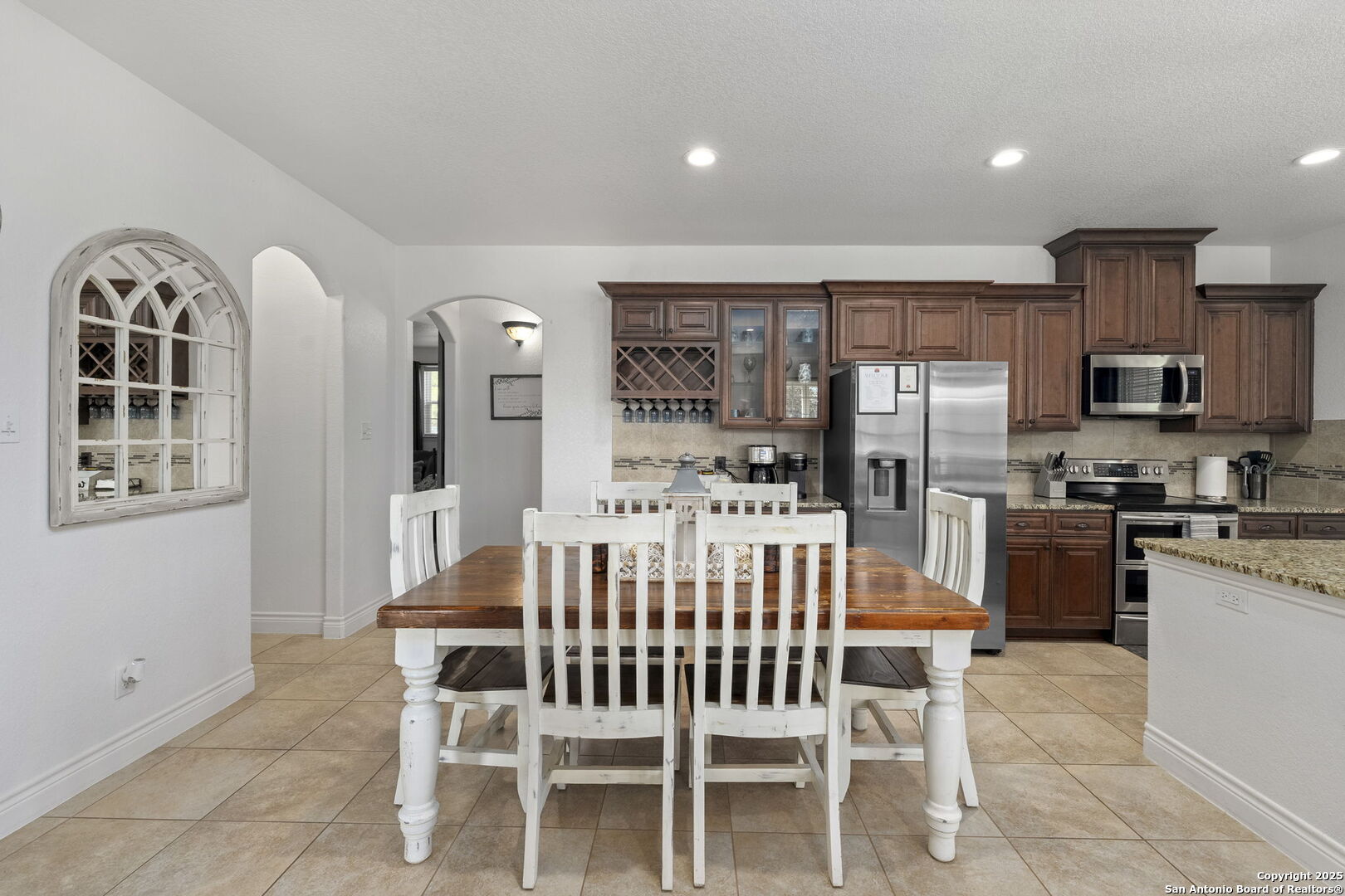 1608 Lake Ridge Boulevard Canyon Lake, TX 78133 - Photo 13 of 46 a view of kitchen with stainless steel appliances kitchen island granite countertop dining table chairs sink and cabinets