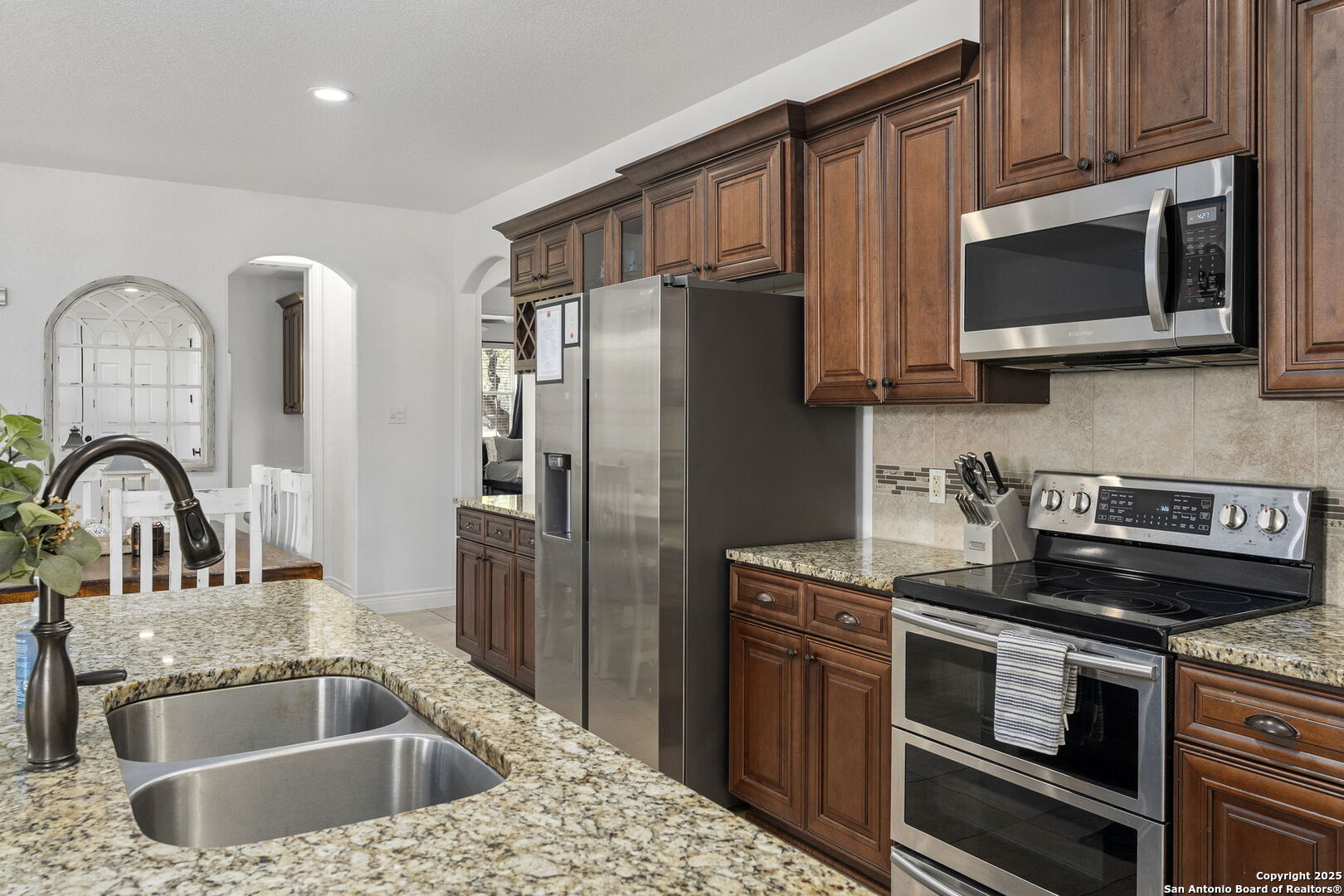 1608 Lake Ridge Boulevard Canyon Lake, TX 78133 - Photo 15 of 46 a kitchen with a sink stove and refrigerator