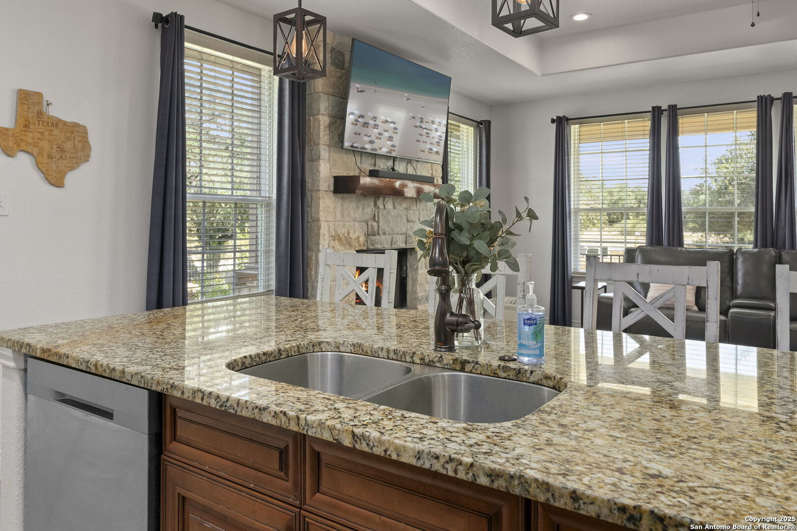 1608 Lake Ridge Boulevard Canyon Lake, TX 78133 - Photo 16 of 46 a kitchen with a granite countertop sink and natural light