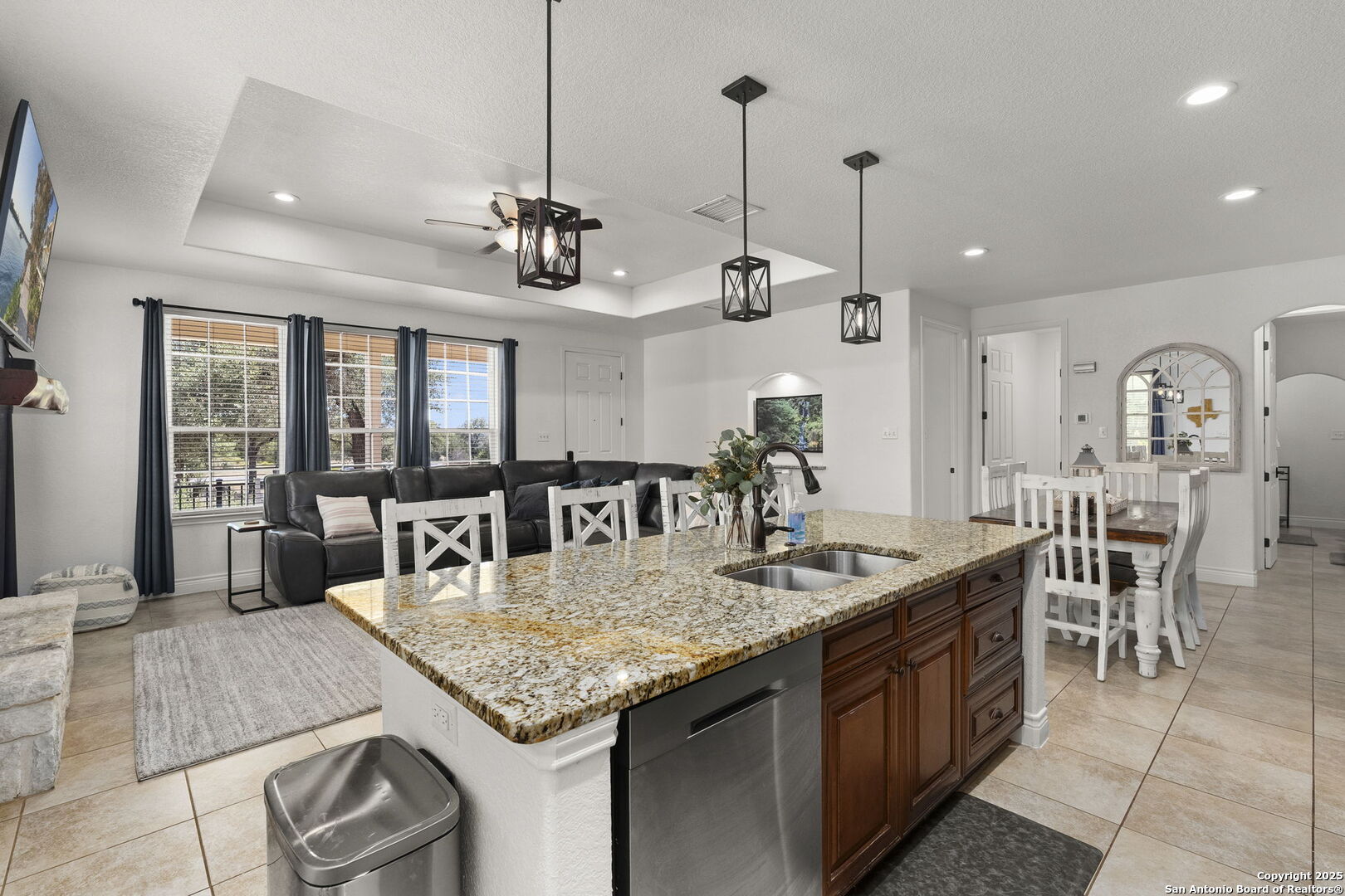 1608 Lake Ridge Boulevard Canyon Lake, TX 78133 - Photo 17 of 46 a kitchen with granite countertop cabinets a dining table and chairs