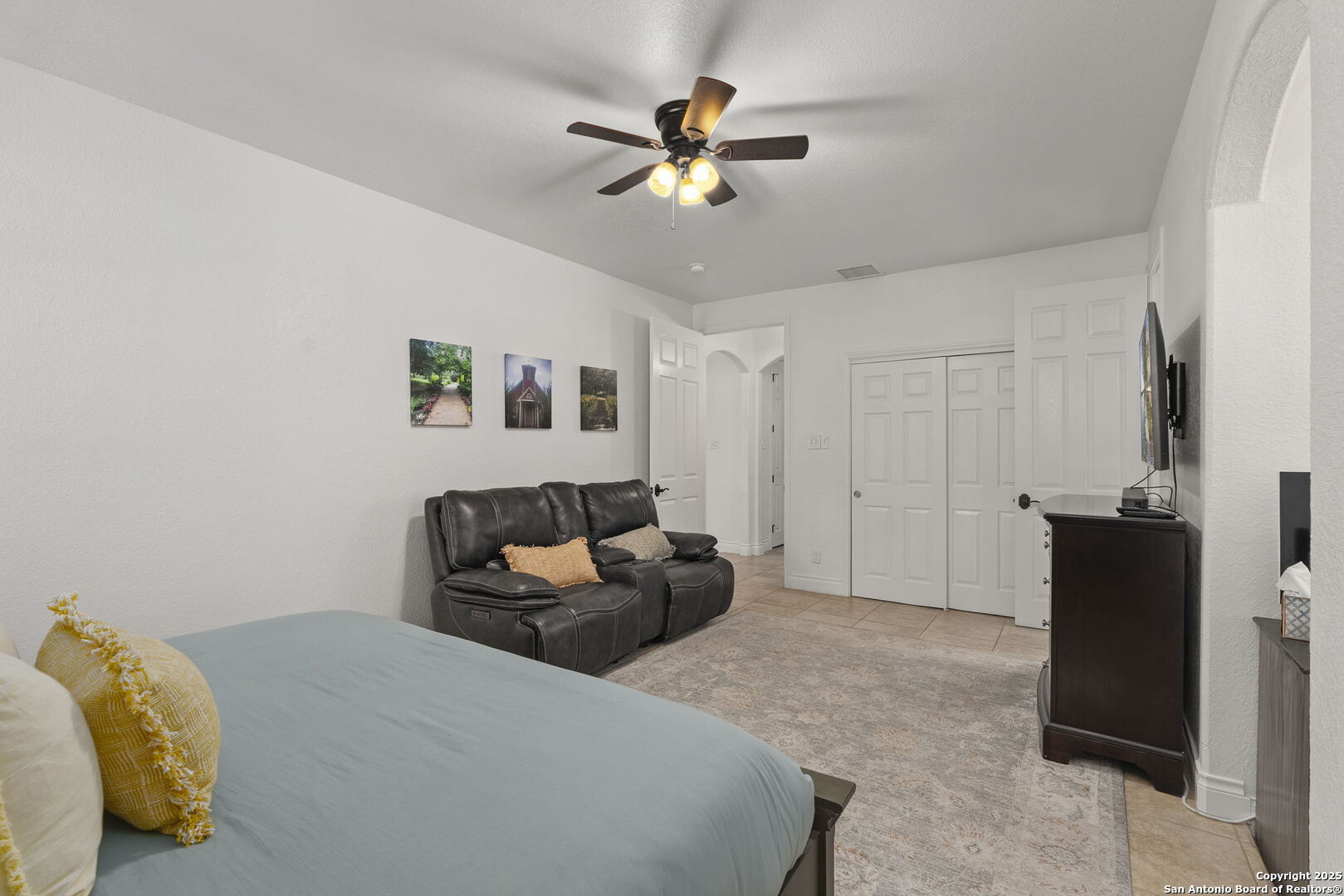 1608 Lake Ridge Boulevard Canyon Lake, TX 78133 - Photo 25 of 46 a bedroom with a bed and a chandelier