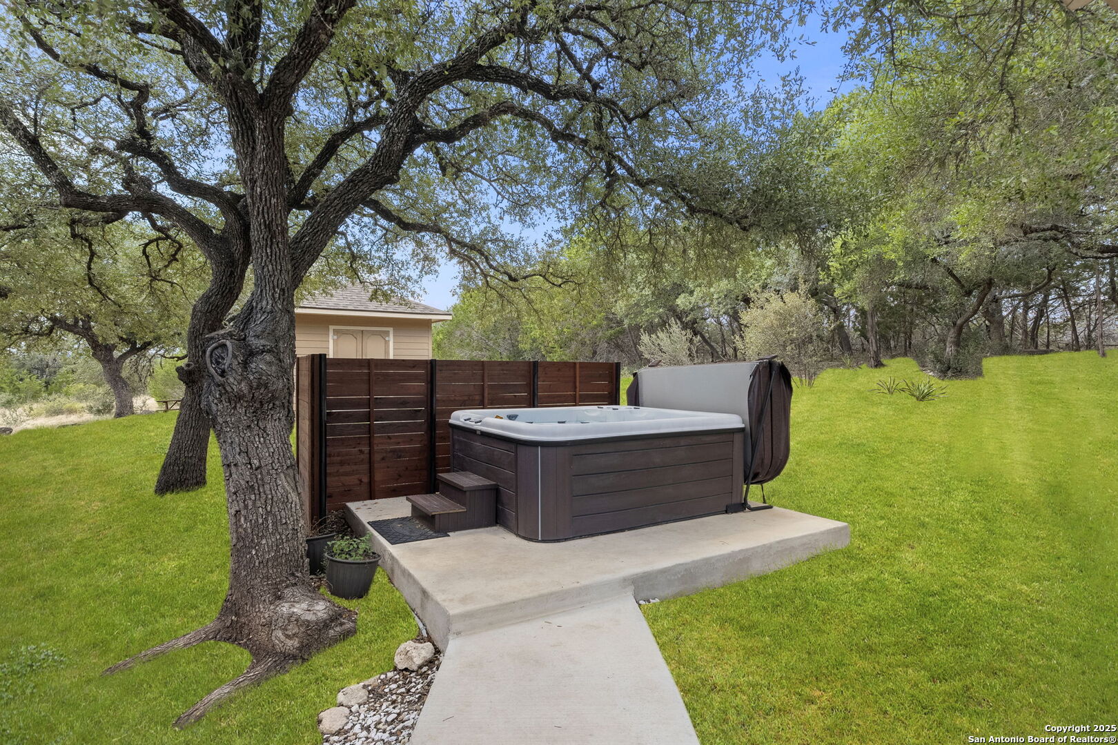 1608 Lake Ridge Boulevard Canyon Lake, TX 78133 - Photo 37 of 46 a view of a backyard with large trees