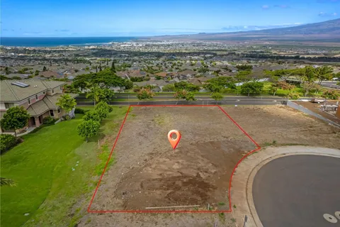 an aerial view of a house with a yard and lake view