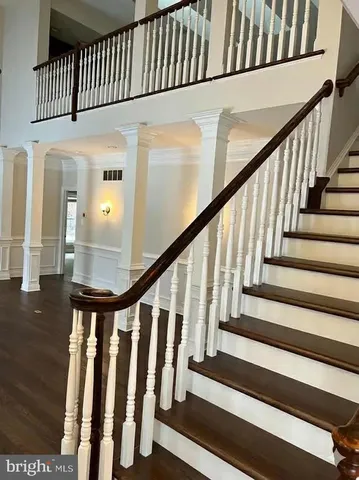 a balcony with wooden floor and fence
