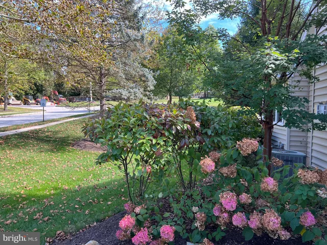 a kitchen with granite countertop white cabinets and white stainless steel appliances