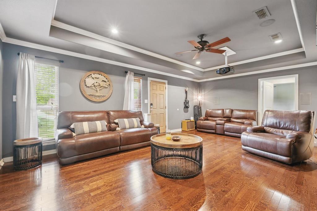 5657 Harmony Ranch Road Aubrey, TX 76227 - Photo 16 of 40 a living room with furniture a rug and a window