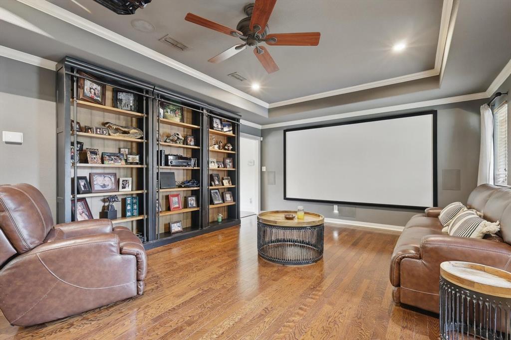 5657 Harmony Ranch Road Aubrey, TX 76227 - Photo 17 of 40 a living room with furniture and a flat screen tv