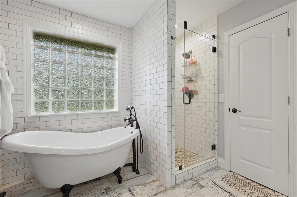 5657 Harmony Ranch Road Aubrey, TX 76227 - Photo 19 of 40 a white bath tub sitting next to a shower