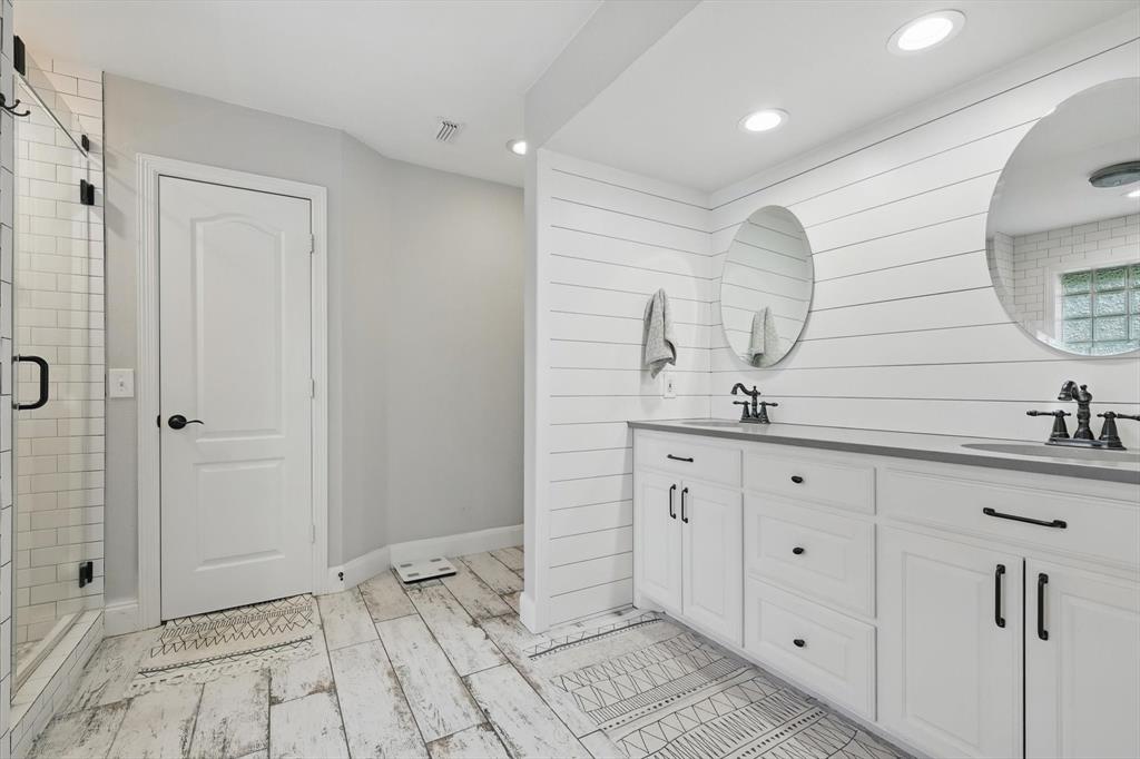 5657 Harmony Ranch Road Aubrey, TX 76227 - Photo 20 of 40 a bathroom with a double vanity sink and mirror