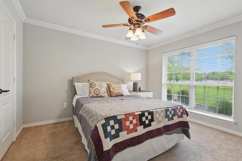 5657 Harmony Ranch Road Aubrey, TX 76227 - Photo 21 of 40 a bedroom with a bed mirror and window