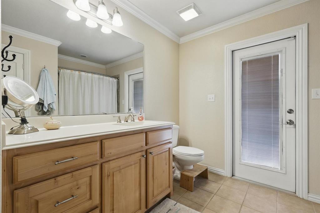 5657 Harmony Ranch Road Aubrey, TX 76227 - Photo 25 of 40 a bathroom with a toilet a sink and mirror