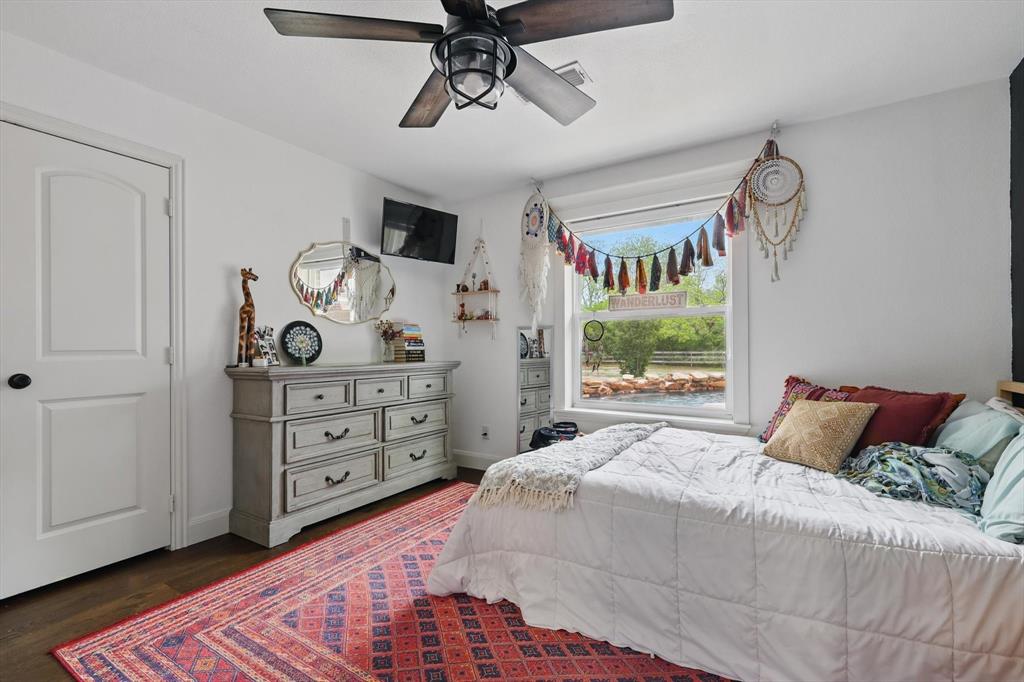5657 Harmony Ranch Road Aubrey, TX 76227 - Photo 26 of 40 a bedroom with a bed and a window