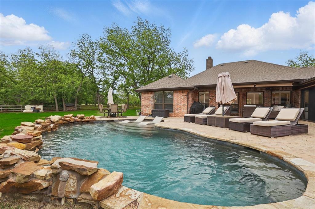 5657 Harmony Ranch Road Aubrey, TX 76227 - Photo 30 of 40 a swimming pool with outdoor seating yard and barbeque oven