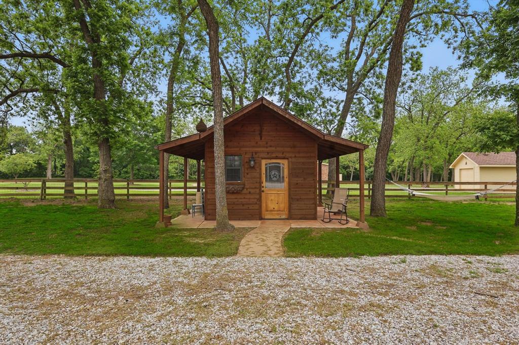 5657 Harmony Ranch Road Aubrey, TX 76227 - Photo 33 of 40 a front view of a house with a yard and trees