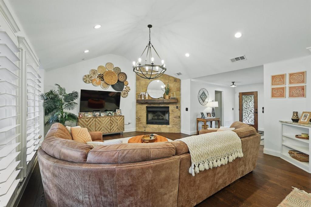 5657 Harmony Ranch Road Aubrey, TX 76227 - Photo 8 of 40 a living room with furniture a fireplace and a flat screen tv
