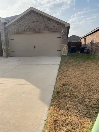 a view of a house with a wooden fence