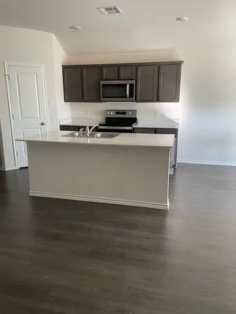 a kitchen with granite countertop a stove and a sink