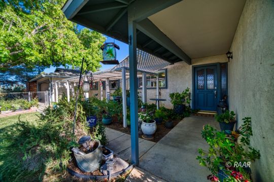 4617 West Ridgecrest Boulevard Ridgecrest, CA 93555 - Photo 21 of 33 a view of a patio with table and chairs potted plants