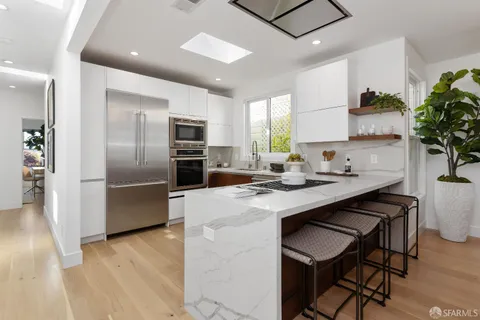 a kitchen with sink cabinets and wooden floor