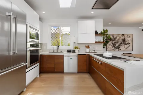 a kitchen with a stove a microwave and cabinets