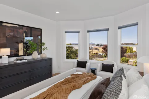 a bedroom with a bed and a couch