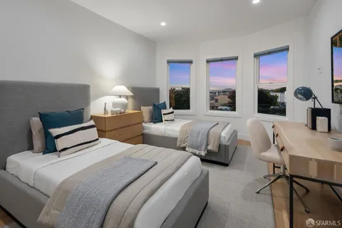 a bedroom with bed mirror and window