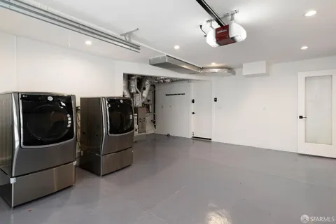 a view of a refrigerator in kitchen and a window