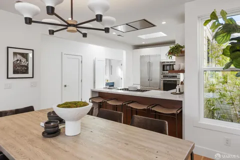 a kitchen with kitchen island a counter space a sink appliances and cabinets