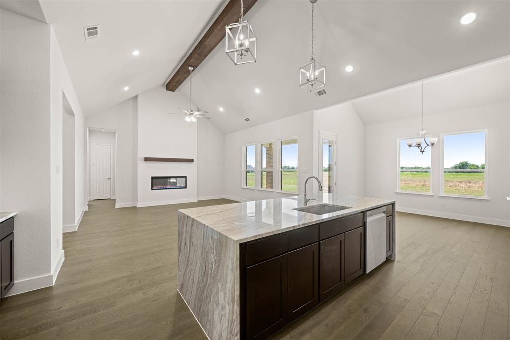 221 Olson Road Waxahachie, TX 75167 - Photo 11 of 24 a kitchen with kitchen island a sink stainless steel appliances and a counter top space