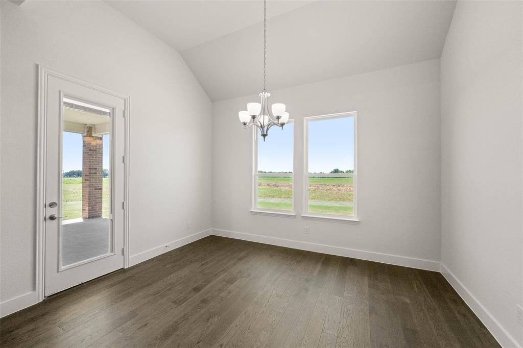 221 Olson Road Waxahachie, TX 75167 - Photo 12 of 24 an empty room with wooden floor and windows