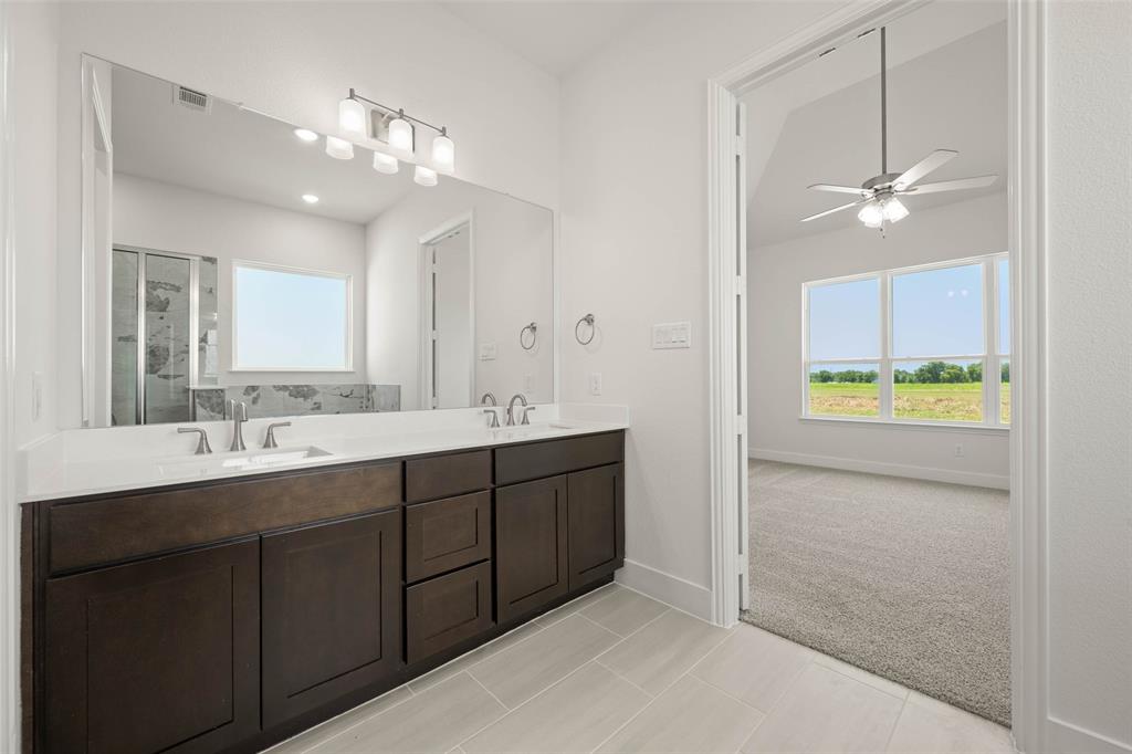 221 Olson Road Waxahachie, TX 75167 - Photo 22 of 24 a bathroom with a double vanity sink and a mirror