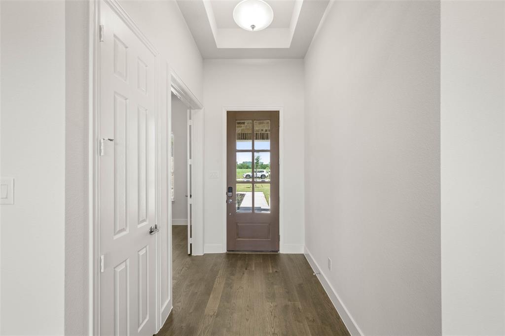 221 Olson Road Waxahachie, TX 75167 - Photo 3 of 24 a view of an empty room with wooden floor and a window