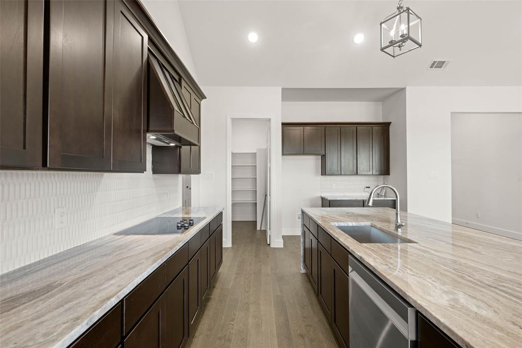 221 Olson Road Waxahachie, TX 75167 - Photo 9 of 24 a kitchen with a sink and a refrigerator