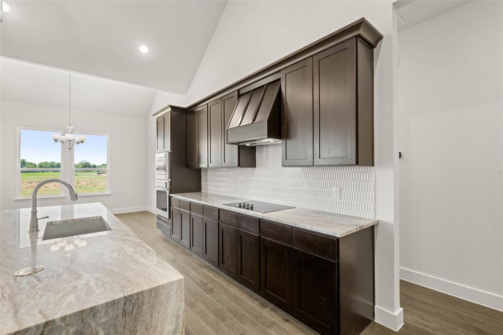 221 Olson Road Waxahachie, TX 75167 - Photo 10 of 24 a kitchen with stainless steel appliances granite countertop a sink and a stove