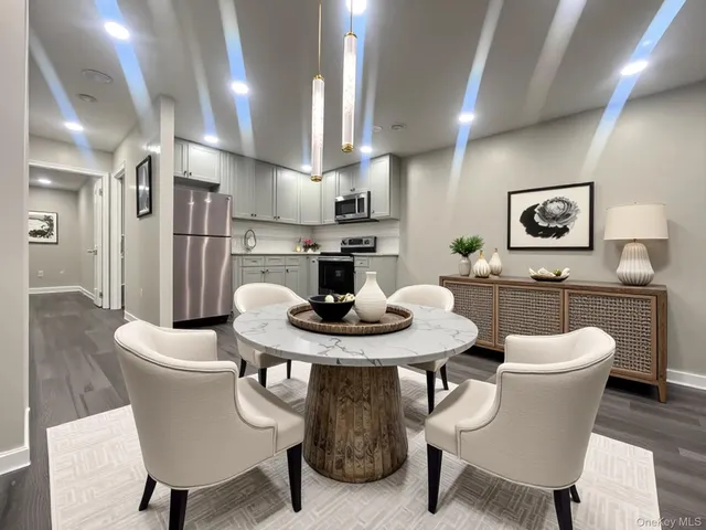 a view of a dining room with furniture and wooden floor