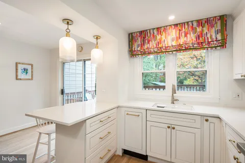 a kitchen with a sink and large window
