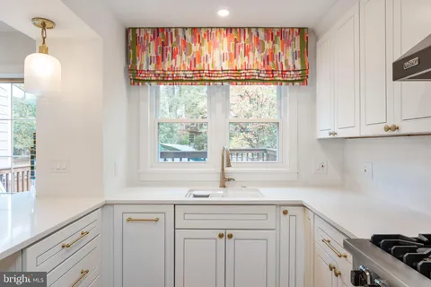 a kitchen with a sink and a window
