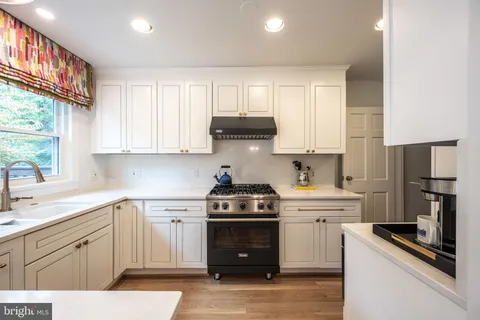 a kitchen with a stove and a sink