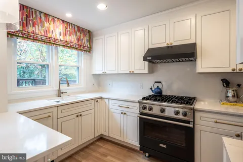 a kitchen with stainless steel appliances granite countertop a sink a stove and a microwave