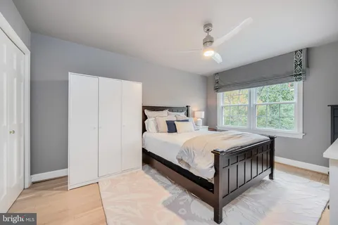 a bedroom with a bed and a large window